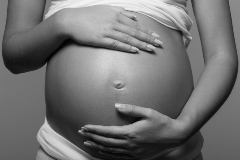 mom-07 Pregnant woman embracing her belly - black and white